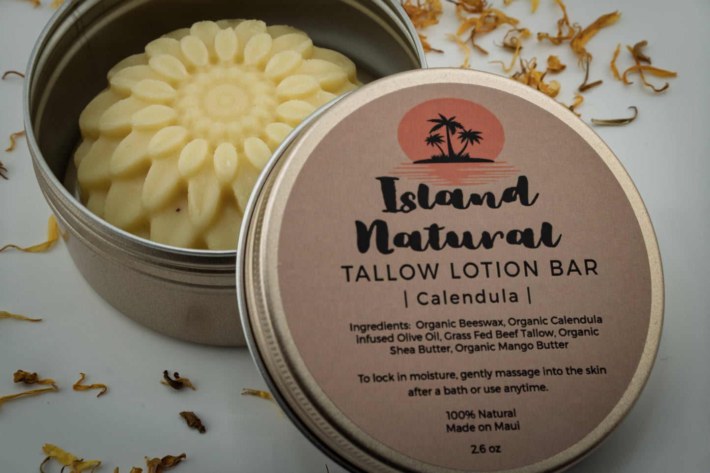 Island Natural Tallow Lotion Bar with calendula in a metal tin on a light background