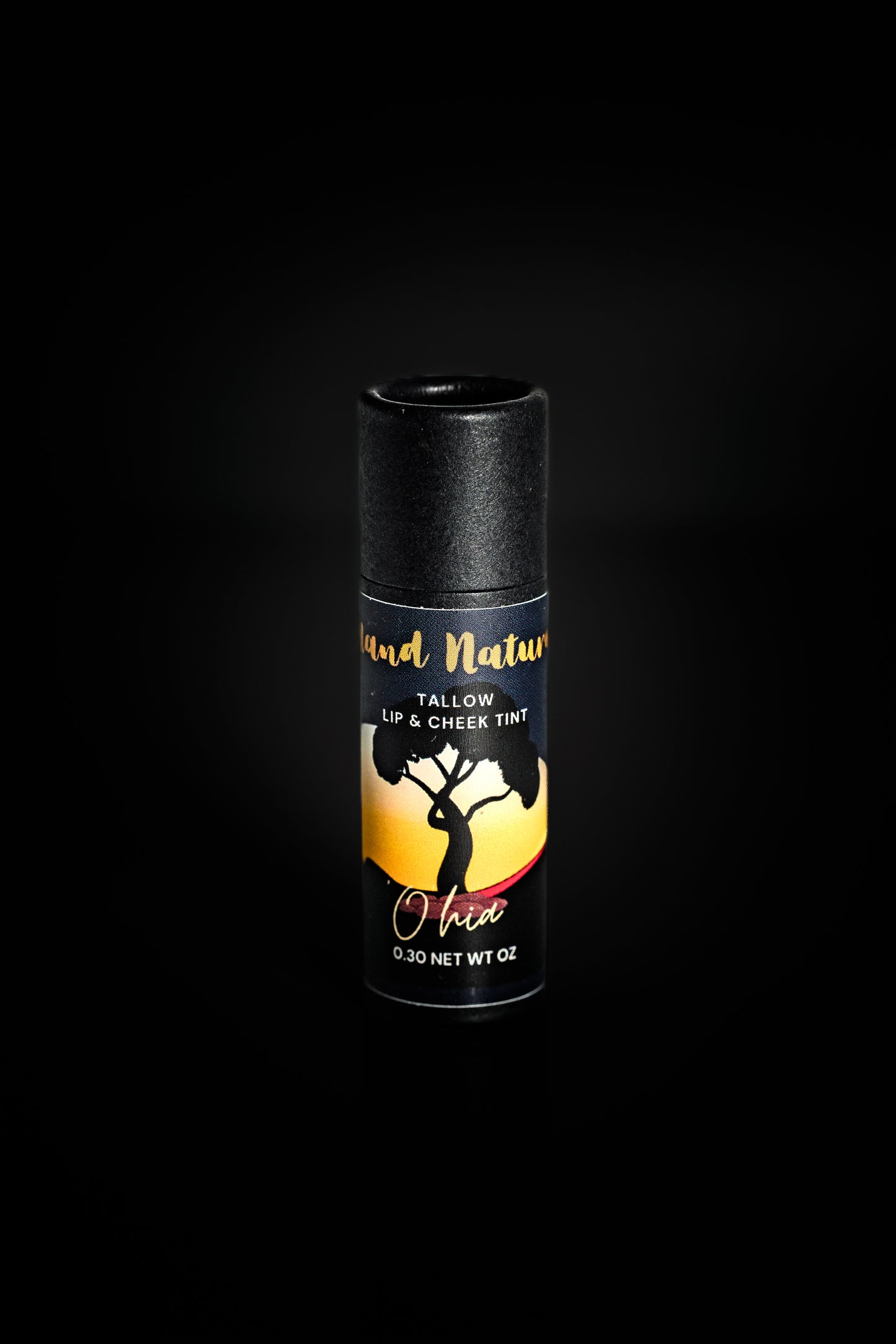 'Ohi'a tallow tinted lip balm with a colorful label on a black background by Island Natural Skincare