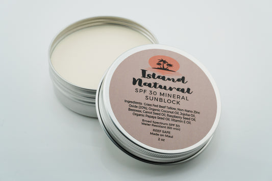 Island Natural Skincare SPF 30 mineral sunscreen in a tin with a label on a light gray background